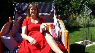 Milf gives footjob in a beach chair